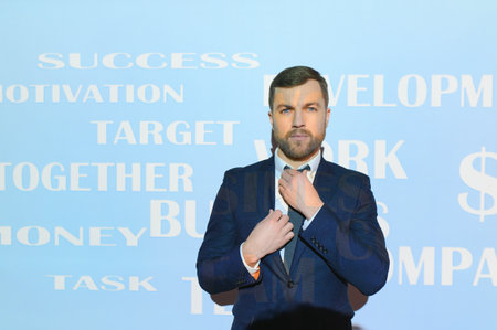 portrait of a successful and handsome businessman in a suit. Different motivational words on the...