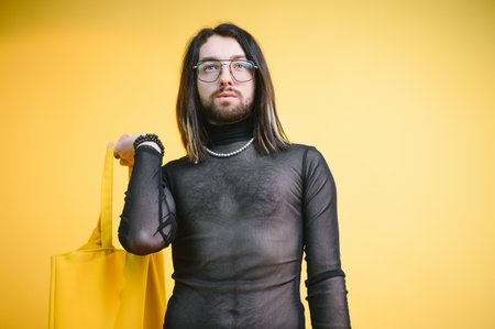 Gay man on a colored background in the studio. The concept of the LGBTQ community. Equality