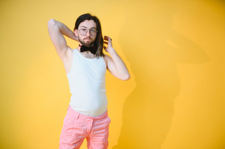 Gay man on a colored background in the studio. The concept of the LGBTQ community. Equality