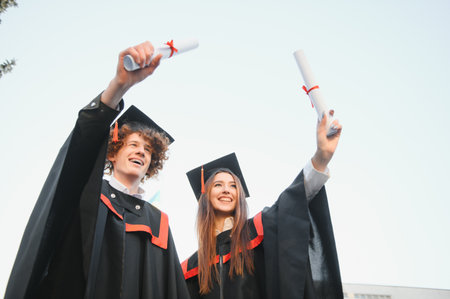 Portrait of two happy advancing studentsの写真素材