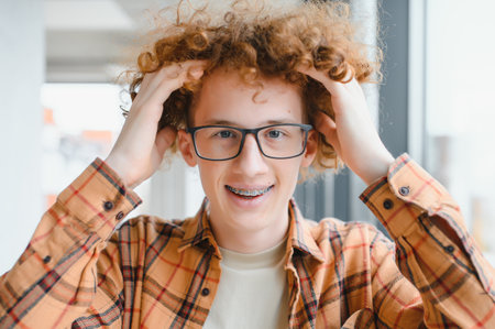 cute red-haired guy wearing stylish glasses yellow t-shirtの写真素材