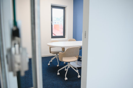 Modern meeting room interior with table and chairs.