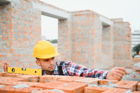 Construction worker in uniform and safety equipment have job on building.の写真素材