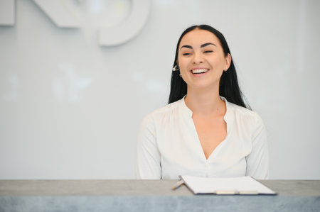 Portrait of beautiful receptionist near counter in hotel.の写真素材