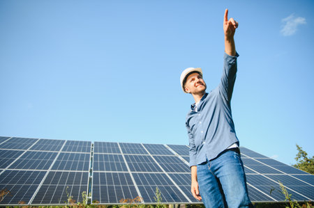 Solar power plant. Engineer on a background of photovoltaic panels. Science solar energyの写真素材