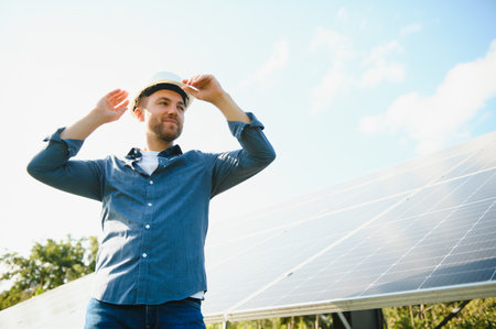 Young architect standing by solar panels.の写真素材