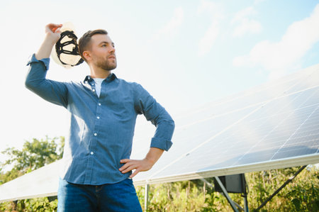 Young architect standing by solar panels.の写真素材