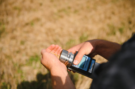 a farmer checks wheat moisture meterの写真素材