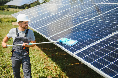 young worker cleaning solar panelsの写真素材