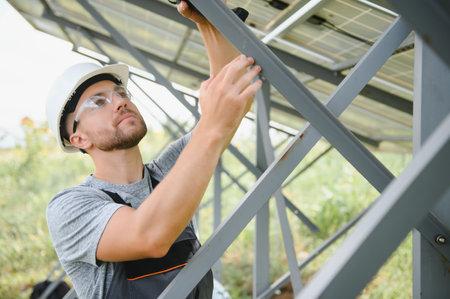 A man working at solar power stationの写真素材
