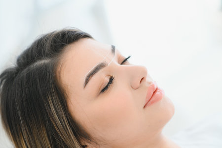 Young woman during professional eyebrow mapping procedureの写真素材