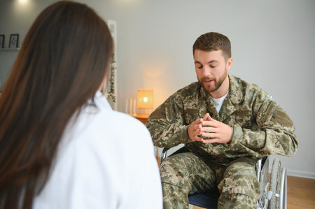 Young soldier in wheelchair at psychologist's office.の写真素材