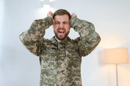 Military veteran with post traumatic stress disorder screaming at home.の写真素材