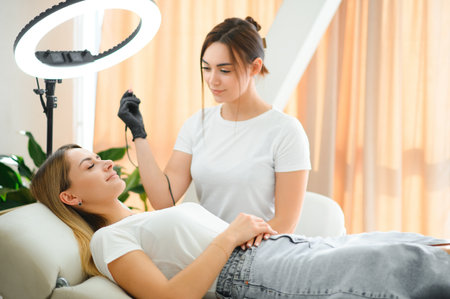 Process of creating permanent brow makeup with a machine at beauty salon.の写真素材
