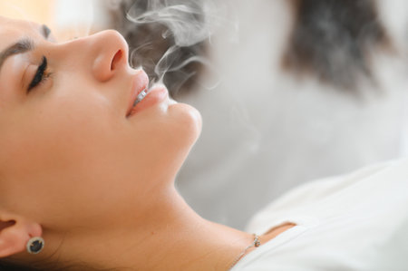 Woman smoking, close up on smoke and mouth.の写真素材