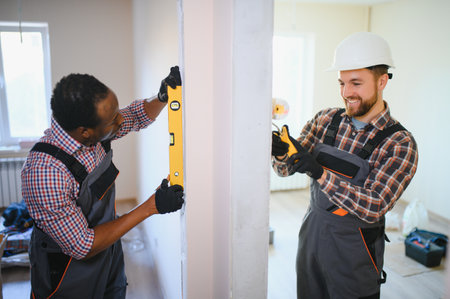 two workers are making repairs in the apartment.の写真素材