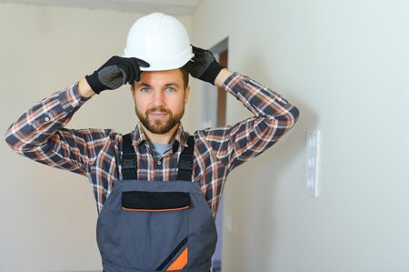 Portrait of a construction worker or repairman in the house.