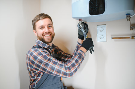 worker set up central gas heating boiler at home.の写真素材