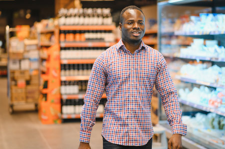 Attractive african american man shopping in a supermarket.の写真素材