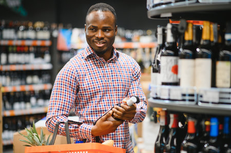 African American man in grocery store buying wine.の写真素材