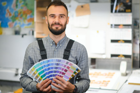 Typographer standing with color swatches at the printing manufacturing.の写真素材