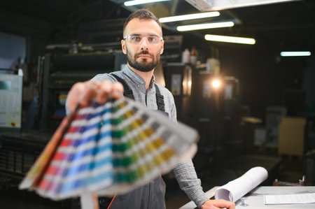 Typographer standing with color swatches at the printing manufacturing.の写真素材