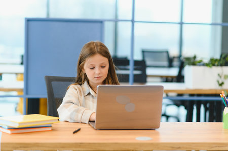 Wow, Online School. Happy Schoolgirl At Laptop Learning And Gesturing Thumbs Up To Camera, Approving Great Online Lesson And Educational Offer Posing At Home, Sitting At Table Indoorの写真素材