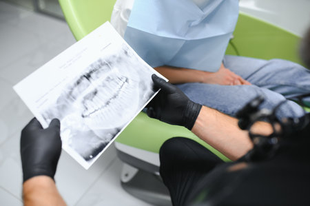 Dentist shows an X-ray of jaw. Dentist services concept.