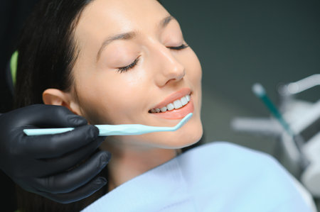 Dentist examining patient's teeth, close up.の写真素材