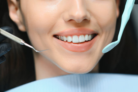 Dentistry concept, partial portrait of girl with strong white teeth. Closeup of young woman at dentist's, studio, indoors.の写真素材