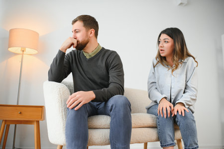 Family conflict, quarrel, misunderstanding. The woman shouts at her husband, in despair, crying.の写真素材