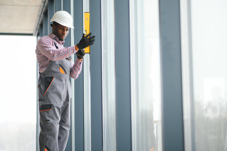 Construction worker repairing plastic window with screwdriver indoors, space for text. Banner design