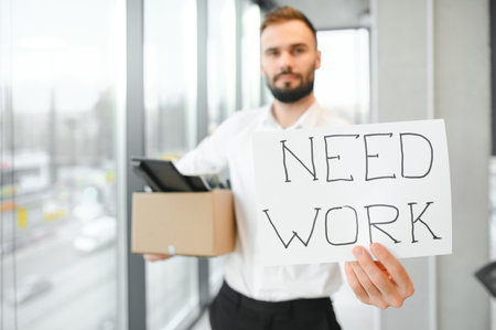 Business, Firing and Job Loss Concept - Sad Fired Male Office Worker With Box of His Personal Stuff.の写真素材