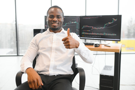 Stock Market Day Trader Working on Computer with Multi-Monitor Workstation with Real-Time Investment Charts.の写真素材