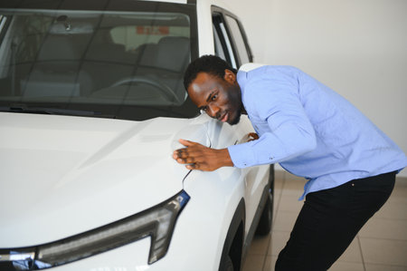 Car Buyer. Black Guy Choosing New Automobile In Dealership Store.の写真素材