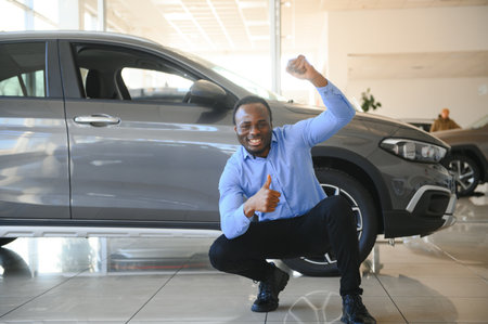 Car Buyer. Black Guy Choosing New Automobile In Dealership Store.