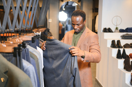 Young african man shopping in clothing store.の写真素材