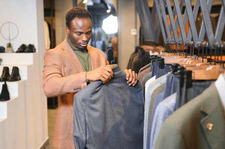 A handsome young African gentleman buying an elegant suit.の写真素材