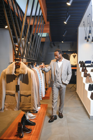 Handsome young African man wearing suit in shop.の写真素材
