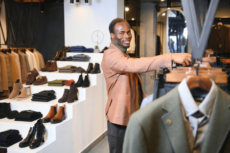 Handsome young African man wearing suit in shop.の写真素材
