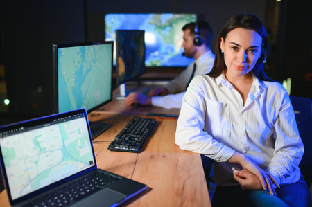 Friendly smiling woman call center operator with headset using computer at office.