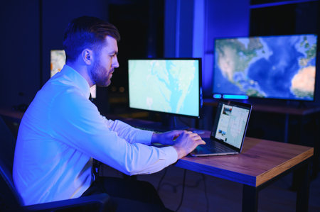 Photo of a successful dispatcher working on a computer in the office.