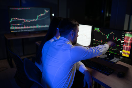 Financial Analyst Talking to Investment Banker in Late Evening at Work.