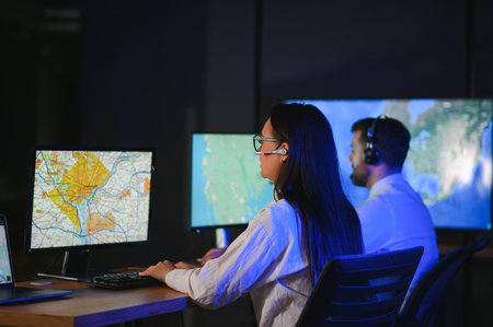 Center of dispatching maintenance. Portrait of cheerful woman and man working via headset microphone...