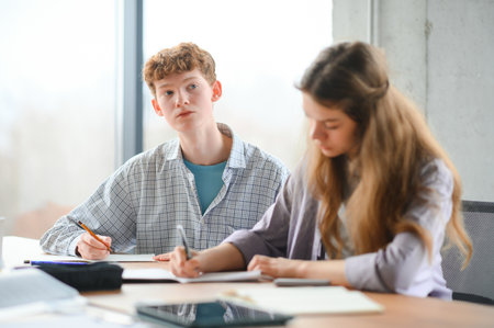 Group of college students doing homework.