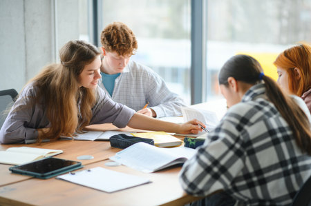 Group of college students doing homework.