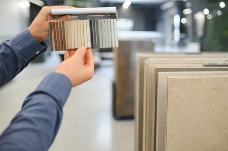 man choosing ceramic tiles and utensils for his home bathroom.