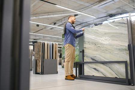 man choosing ceramic tiles and utensils for his home bathroom.