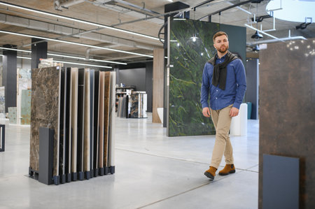 Middle age man choosing ceramic tiles and utensils for his home bathroom.