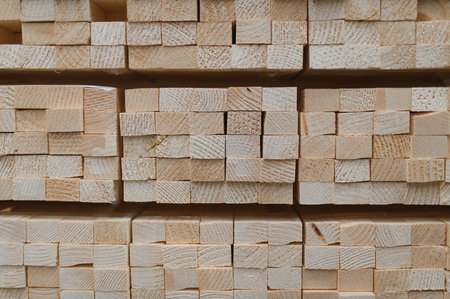 Perspective angle of wooden planks in close-up at a lumber warehouse. Background of boardsの写真素材